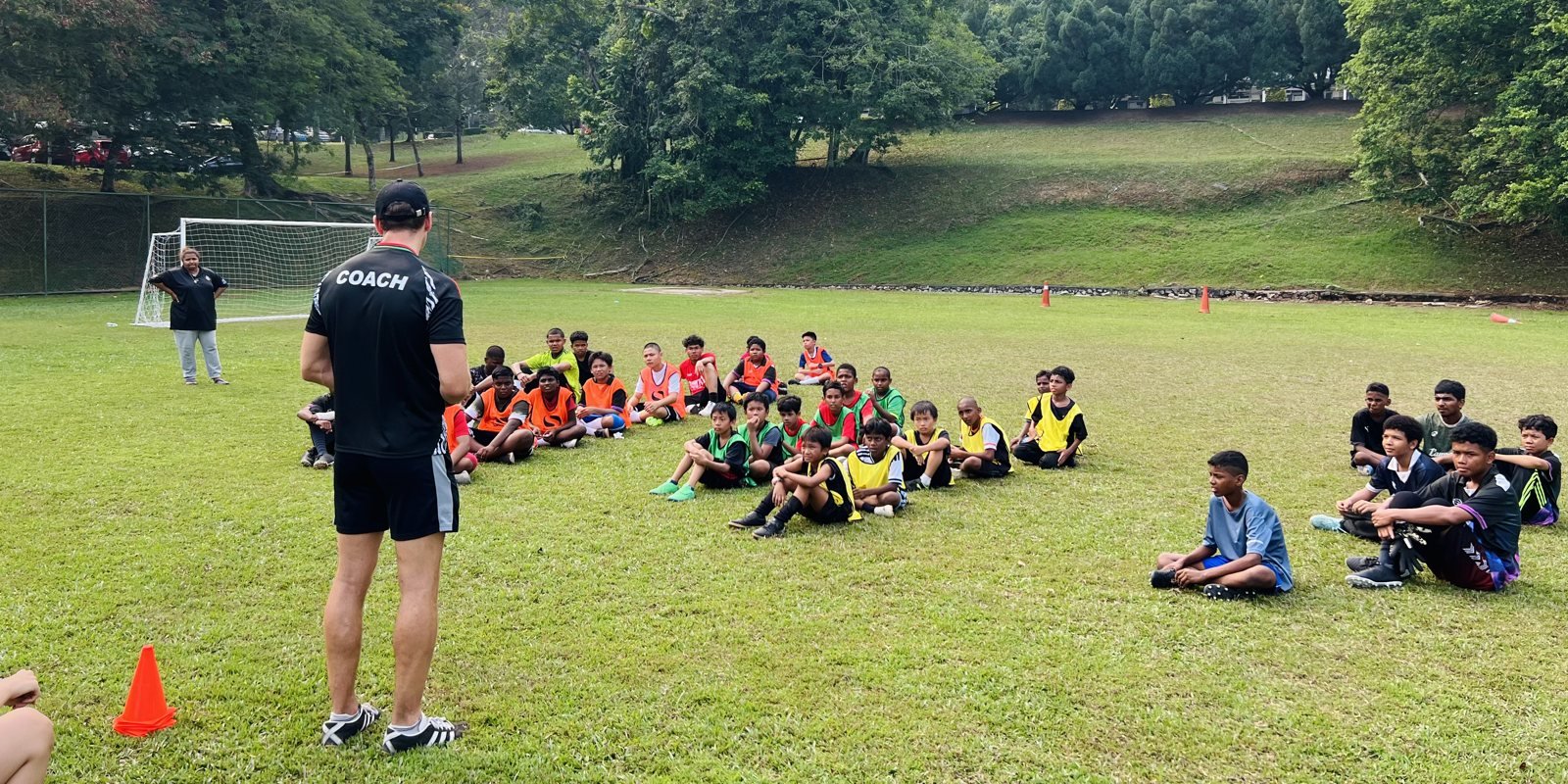 Coach standing in front of the group during a briefing